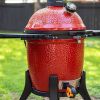 1. Wireless meat thermometer on a red kamado-style grill for precise cooking control.