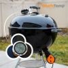 Digital wireless grilling thermometer on a black BBQ grill for precise cooking temperature control.