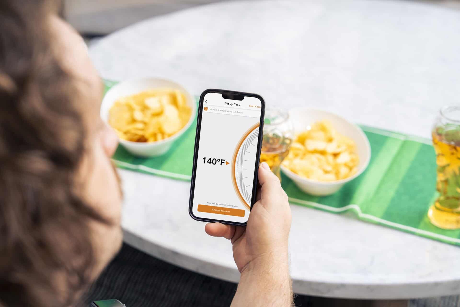 Smart food thermometer app monitoring food temperature during cooking for safety and precision.