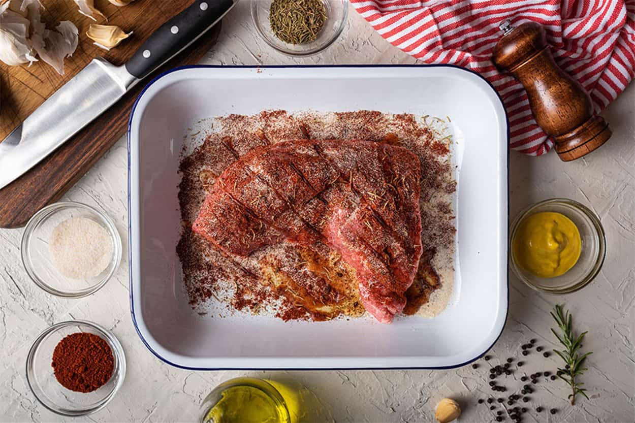 rubbing santa maria style sauce on tri-tip steak rubbing santa maria style sauce on tri-tip steak
