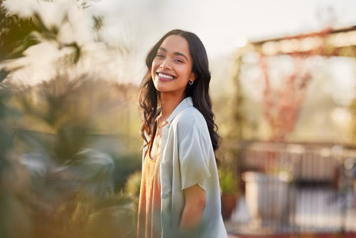 Portrait of beautiful happy woman smiling during sunset outdoor emily