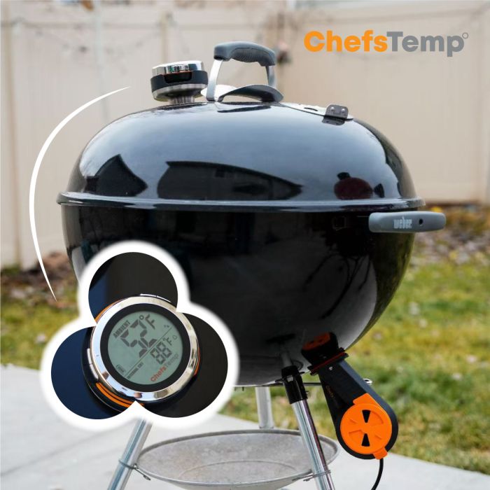 Digital wireless grilling thermometer on a black BBQ grill for precise cooking temperature control.