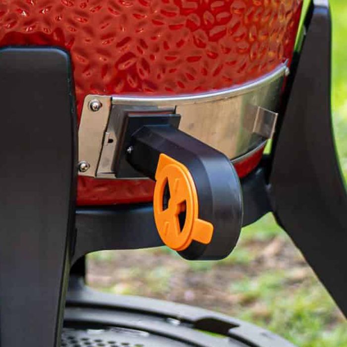 Wireless grilling thermometer probe attached to a barbecue grill.