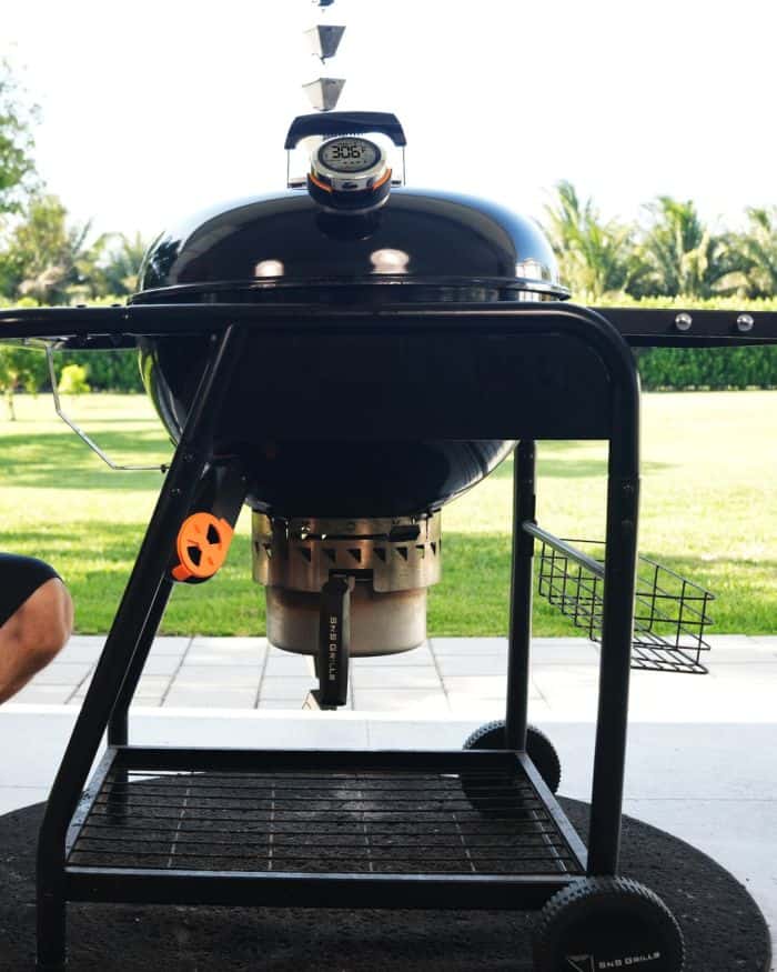 Outdoor barbecue grill with digital thermometer for optimal cooking temperature tracking.