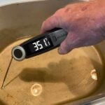 High-precision digital food thermometer measuring pan temperature with 35.1°F reading.