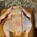 Precise raw chicken ready for cooking with ChefsTemp thermometer in kitchen setting.