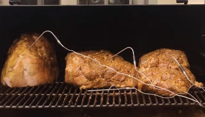 Succulent smoked meats with probe thermometers for perfect cooking temperature.