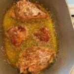 Juicy fried chicken cooking in hot oil for crispy texture and flavor.