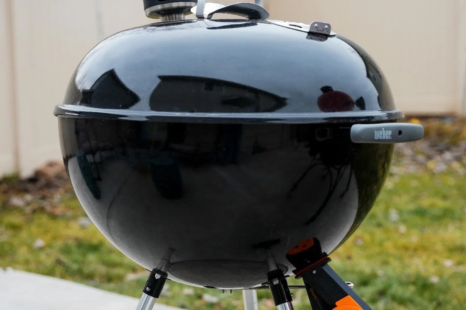 Person checking meat with a probe on an open RECTEQ barbecue smoker with a digital temperature controller.